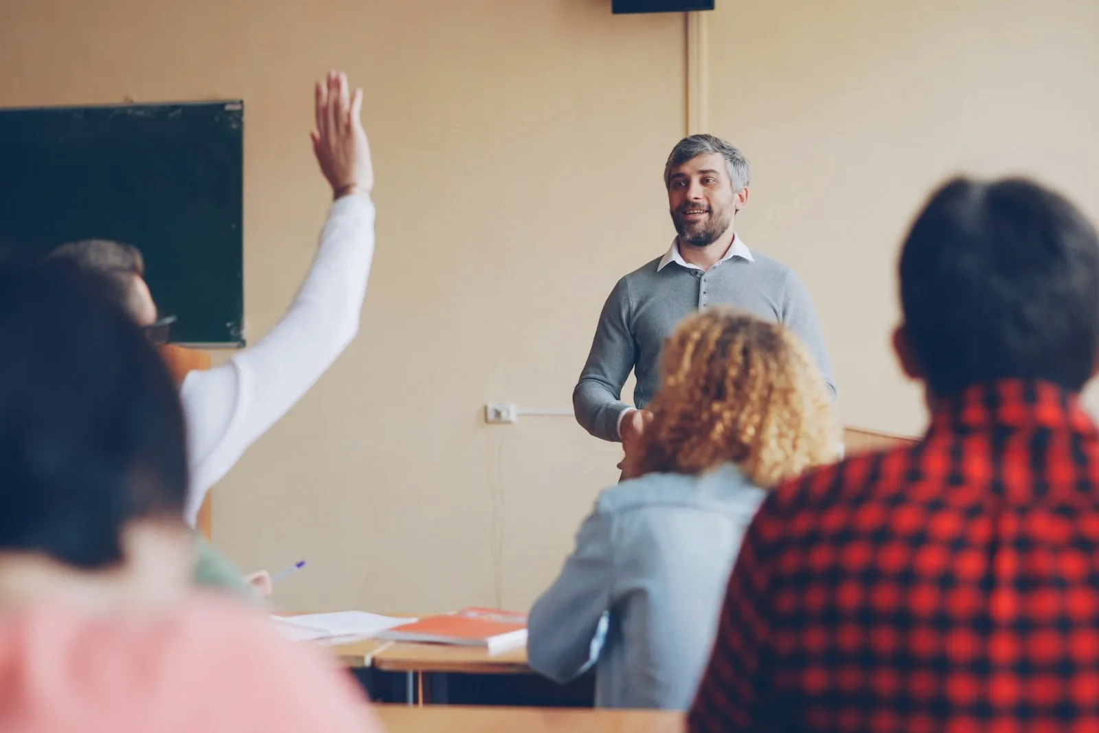 Teacher asking a question to students in a classroom